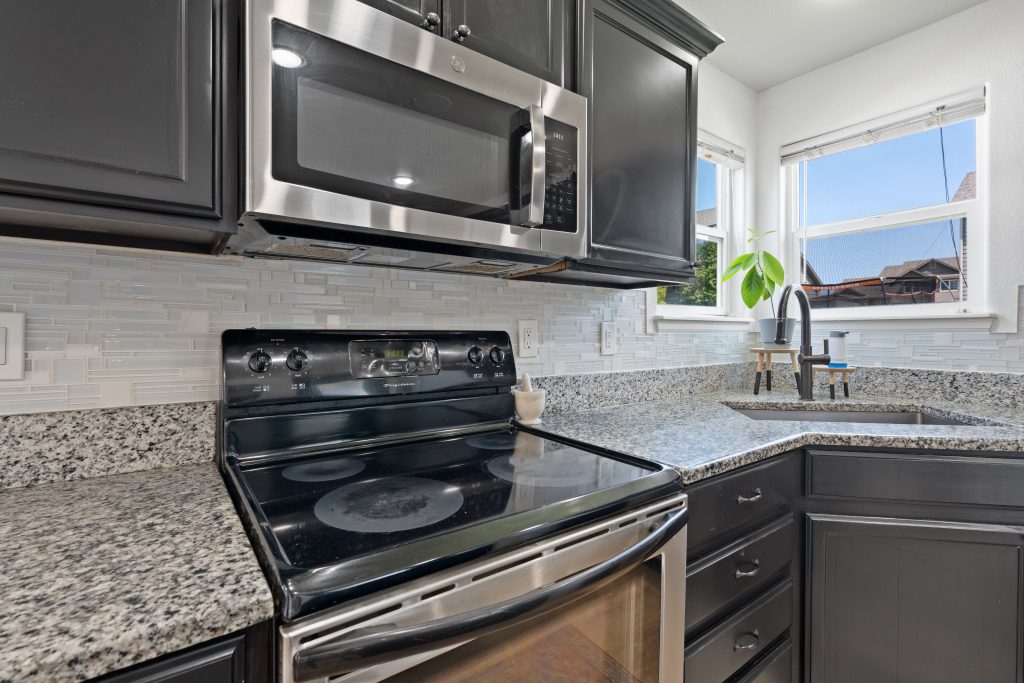 Image of a kitchen showing an above stove microwave oven